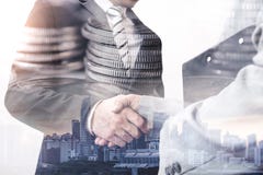 The double exposure image of the businessman handshaking with another one during sunrise overlay with coin stack image. royalty free stock photos The double exposure image of the businessman handshaking with another one during sunrise overlay with coin stack image. royalty free stock photos
