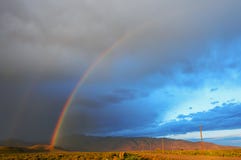 Double Rainbow Over Desert Landscape