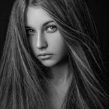 Dramatic portrait of a girl theme: portrait of a beautiful lonely girl with flying hair in the wind isolated on dark background in royalty free stock photo Dramatic portrait of a girl theme: portrait of a beautiful lonely girl with flying hair in the wind isolated on dark background in royalty free stock photo