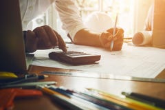 Drawing engineer calculate size of house for renovation with old stock image Drawing engineer calculate size of house for renovation with old stock image