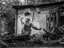 Drawing of a Russian soldier with a gun on the wall of the ruins stock images Drawing of a Russian soldier with a gun on the wall of the ruins stock images