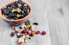 Dried plum and grapes in a Cup on a black and white background top view horizontal stock images Dried plum and grapes in a Cup on a black and white background top view horizontal stock images