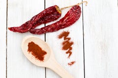 Dried red hot chili peppers on a wooden white background. Flat l Stock Images Dried red hot chili peppers on a wooden white background. Flat l Stock Images