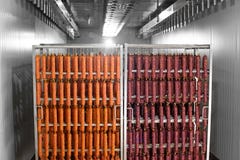 Dried sausage hanging on a rope on a metal frame in the smoke house. stock image Dried sausage hanging on a rope on a metal frame in the smoke house. stock image