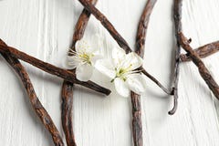 Dried vanilla sticks and flowers on light wooden background Stock Photography Dried vanilla sticks and flowers on light wooden background Stock Photography