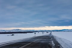 Drifting snow sweeps the road to the mountains in a gloomy sky, Altai, Russia stock photography Drifting snow sweeps the road to the mountains in a gloomy sky, Altai, Russia stock photography
