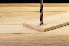 Drilling hole in to wooden plank. Carpentry concept stock photography Drilling hole in to wooden plank. Carpentry concept stock photography