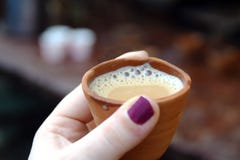 Drinking chai the traditional way stock image Drinking chai the traditional way stock image