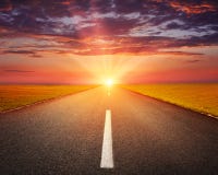 Driving on an empty asphalt road at sunset stock photography Driving on an empty asphalt road at sunset stock photography