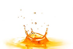 Drop falling into orange water with splash isolated on white stock image Drop falling into orange water with splash isolated on white stock image