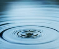 Droplet falling in blue water Stock Image Droplet falling in blue water Stock Image