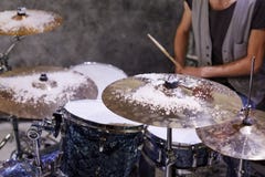 Drummer sits at drumset