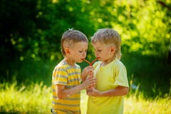 Duas crianças bonitas, amigos de menino, água potável no parque fotos de stock Duas crianças bonitas, amigos de menino, água potável no parque fotos de stock