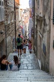 View of people on a narrow street with steep stairs in the old town of Dubrovnik Croatia royalty free stock images View of people on a narrow street with steep stairs in the old town of Dubrovnik Croatia royalty free stock images