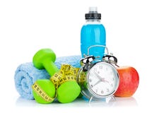 Due dumbells verdi, misura di nastro, alimento sano e sveglia fotografie stock Due dumbells verdi, misura di nastro, alimento sano e sveglia fotografie stock