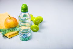 Dumbbells, An Apple, A Towel And A Bottle Of Water Stock Photos