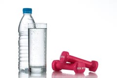 Dumbbells and a bottle of fresh water studio shot stock image Dumbbells and a bottle of fresh water studio shot stock image