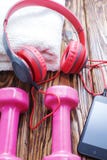 Dumbbells With Towel On Wooden Background, Concept Preparing To Fitness Sports Equipment Top View. Headphones And Phone. Music In Royalty Free Stock Image Dumbbells With Towel On Wooden Background, Concept Preparing To Fitness Sports Equipment Top View. Headphones And Phone. Music In Royalty Free Stock Image