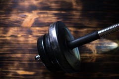 Dumbbells on a wooden dark background. Concept of playing sports Stock Images Dumbbells on a wooden dark background. Concept of playing sports Stock Images