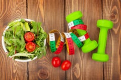 Dumbells, tape measure and healthy food. Fitness and health