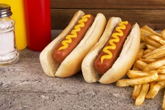 Duo of hot dogs and french fries on table. Fast food concept. Duo of hot dogs and french fries on table. Fast food restaurant concept. Close up stock images Duo of hot dogs and french fries on table. Fast food concept. Duo of hot dogs and french fries on table. Fast food restaurant concept. Close up stock images