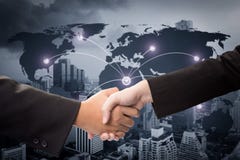 Dwa biznesmena trząść ręki na tło mapie zdjęcia stock Dwa biznesmena trząść ręki na tło mapie zdjęcia stock
