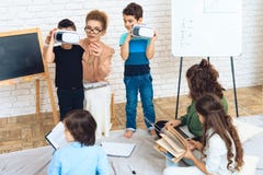 Dwa chłopiec dostają obeznanymi z technologią rzeczywistość wirtualna w sala lekcyjnej fotografia stock Dwa chłopiec dostają obeznanymi z technologią rzeczywistość wirtualna w sala lekcyjnej fotografia stock