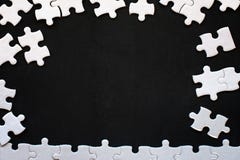 Détails blancs de puzzle sur le fond noir Avec l'espace de copie image libre de droits Détails blancs de puzzle sur le fond noir Avec l'espace de copie image libre de droits