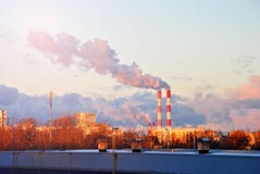 Early morning with down sun light, a view to the industrial landscape of the city with smoke emissions from chimneys Stock Photos Early morning with down sun light, a view to the industrial landscape of the city with smoke emissions from chimneys Stock Photos