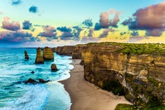 Early morning on the ocean coast. The clouds which have turned pink at dawn over the well-known rocks Twelve apostles . Travel royalty free stock photo Early morning on the ocean coast. The clouds which have turned pink at dawn over the well-known rocks Twelve apostles . Travel royalty free stock photo