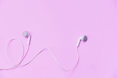 Earphons on pink background / Music is my life and Entertainment listen to music concept stock photography Earphons on pink background / Music is my life and Entertainment listen to music concept stock photography