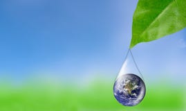 Earth in water drop reflection under green leaf. Royalty Free Stock Photography Earth in water drop reflection under green leaf. Royalty Free Stock Photography