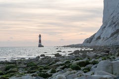 19/09/2018 Eastbourne, United Kingdom. Beachy Head lighthouse in the sea and the sunset on the background. stock photography 19/09/2018 Eastbourne, United Kingdom. Beachy Head lighthouse in the sea and the sunset on the background. stock photography