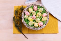 Top view of Easter colorful eggs in a wicker basket on a wooden background. Easter greeting card. Royalty Free Stock Images Top view of Easter colorful eggs in a wicker basket on a wooden background. Easter greeting card. Royalty Free Stock Images