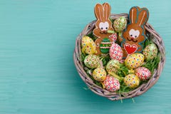 Top view of Easter quail eggs and cookies shaped like a bunny in a wicker basket on a blue background. stock photography Top view of Easter quail eggs and cookies shaped like a bunny in a wicker basket on a blue background. stock photography