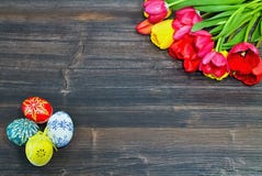 Easter background on a wooden board with Easter eggs and tulips. royalty free stock images Easter background on a wooden board with Easter eggs and tulips. royalty free stock images