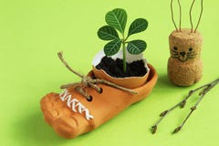 Fragile tender sprout in eggshell in brown ceramic shoe with jute cord, homemade Easter bunny from cork and paper clips and birch stock photo Fragile tender sprout in eggshell in brown ceramic shoe with jute cord, homemade Easter bunny from cork and paper clips and birch stock photo