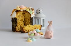 Easter decor with colorful meringues, Easter cake and a pastel pink color bunny. stock photography Easter decor with colorful meringues, Easter cake and a pastel pink color bunny. stock photography