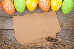 Easter eggs and paper for your greetings on wooden background stock images Easter eggs and paper for your greetings on wooden background stock images