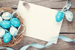 Easter greeting card with blue and white eggs in nest over wood royalty free stock photography Easter greeting card with blue and white eggs in nest over wood royalty free stock photography