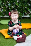 Easter holiday. Cute little girl holding an easter egg. Ivy wall in background stock photography Easter holiday. Cute little girl holding an easter egg. Ivy wall in background stock photography