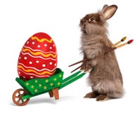 Funny Easter rabbit with a wheelbarrow and an East