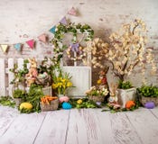 Easter spring sett up with colourful flowers pink and yellow flowers,bunny and easter eggs and vintage wood parquet