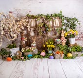 Easter spring sett up with colourful flowers pink and yellow flowers,bunny and easter eggs and vintage wood parquet