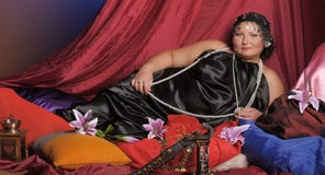Eastern Guria, a well-fed woman in Oriental clothes lies royalty free stock images Eastern Guria, a well-fed woman in Oriental clothes lies royalty free stock images