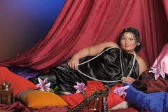 Eastern Guria, a well-fed woman in Oriental clothes lies royalty free stock image Eastern Guria, a well-fed woman in Oriental clothes lies royalty free stock image