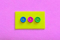Easy Ways To Sew Buttons To Felt. Yellow Felt Piece With Colourful Buttons Isolated On Pink Felt Background Royalty Free Stock Photos Easy Ways To Sew Buttons To Felt. Yellow Felt Piece With Colourful Buttons Isolated On Pink Felt Background Royalty Free Stock Photos