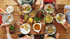 Group of people eating at table with food