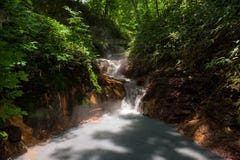 Eau chaude de la rivière d'Oyunumagawa passant de l'étang d'Oyunuma par la vallée Jigokudani d'enfer images stock Eau chaude de la rivière d'Oyunumagawa passant de l'étang d'Oyunuma par la vallée Jigokudani d'enfer images stock