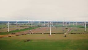 Eco-friendly power industry, scenic aerial background shot of large windmill turbine farm working in autumn field. stock footage Eco-friendly power industry, scenic aerial background shot of large windmill turbine farm working in autumn field. stock footage